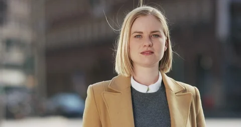 Beautiful blonde smiles while looking towards the camera Video stock 106035332