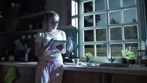 Beautiful blonde using tablet at night Stock Footage 74524474