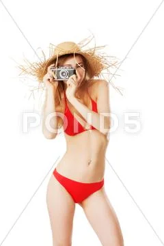 Beautiful blonde woman in bikini taking pictures Stock Photos