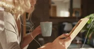 Beautiful Blonde Woman At Home Using Digital Tablet Technology Stock Footage