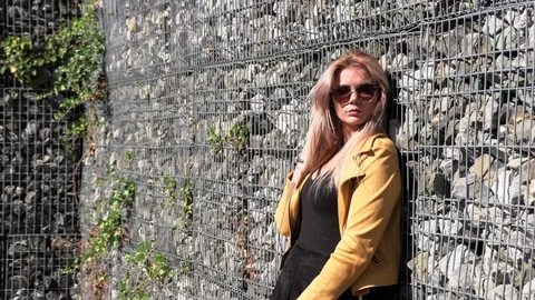 Beautiful blonde in a yellow jacket Stock Footage 117433364