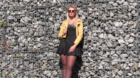 Beautiful blonde in a yellow jacket Stock Footage 117933254