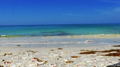 Beautiful blue beach low angle, Man crosses frame,4K Stock Footage 49018493