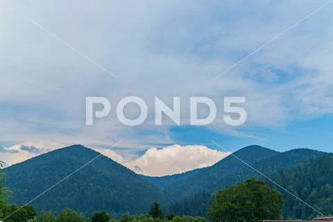 Beautiful blue Carpathian mountains against the background of large cumulus c Stock Photos