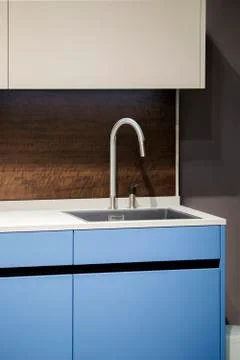 Beautiful blue kitchen unit, kitchen faucet, wooden apron in the kitchen. Mod Stock Photos