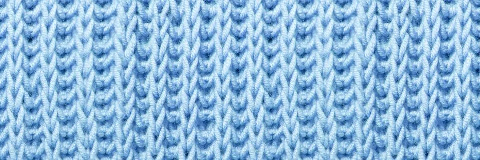 Beautiful blue knitted braid pattern of light wool yarn, seamless knitted t.. Stock Photos