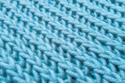 Beautiful blue knitted braid pattern of light wool yarn, knitted texture, c.. Stock Photos