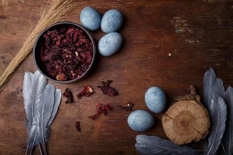 Beautiful blue painted easter eggs with dry Hibiscus tea Stock Photos