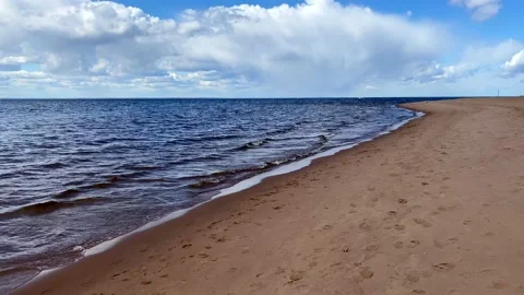 Beautiful blue sea with small waves and a blue sky with white clouds Stock-Footage 130435749
