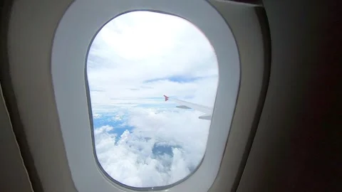 Beautiful blue sky and cloud from an airplane looking window seat Stock Footage 293775537