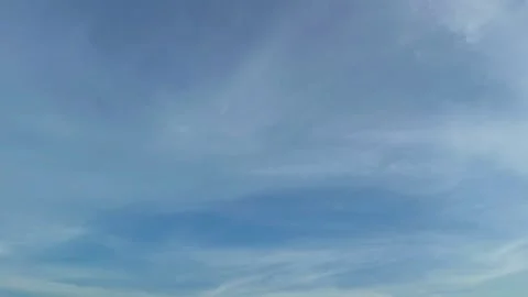 Beautiful blue sky background with moving soft white clouds time lapse video Stock Footage 339931037