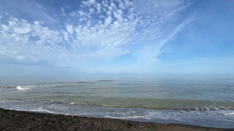 Beautiful blue sky with cirrus clouds over calm sea waves on sandy beach video Stock Footage 346520236
