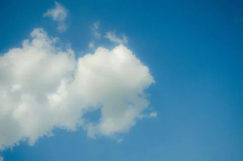 Beautiful blue sky with cloud on the left side of the frame background Stock Photos