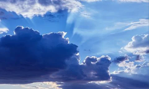 Beautiful blue sky with clouds background. Sunlight Stock Photos