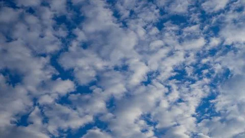 Beautiful blue sky filled with pattern of white fluffy clouds. Natural clouds Photos