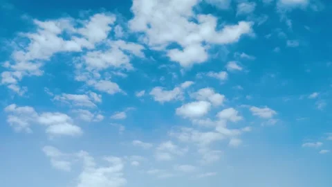 Beautiful Blue Sky with Fluffy White Clouds Moving Gently Across the Horizon Stock Footage 340493373