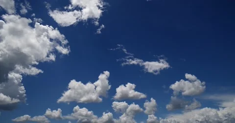 Beautiful blue sky frames time lapsed cumulus clouds, slo pan right then stops Stock Footage 152524215