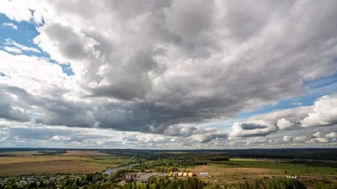 Beautiful blue sky with puffy white clouds over luscious green landscape, time Stock Footage 222799552