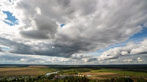 Beautiful blue sky with puffy white clouds over luscious green landscape, time Stock Footage 225166334