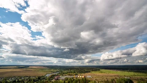 Beautiful blue sky with puffy white clouds over luscious green landscape, time Stock Footage 227404681