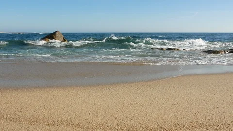 Beautiful blue waves break on sandy shore at beach in summer. Slow zoom in. Stock Footage 108512292