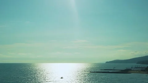 Beautiful Blue Yellow Sky Clouds Sun over the Sea on the Coast Flooded with Sunl Stock Footage 252119971
