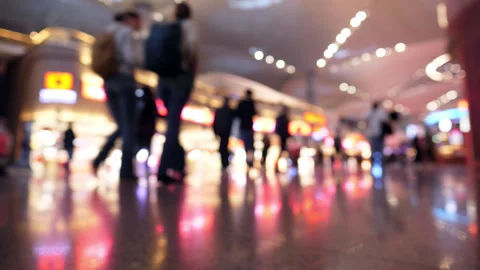 Beautiful blurred background of passengers walking in modern airport terminal Stock Footage 345553479
