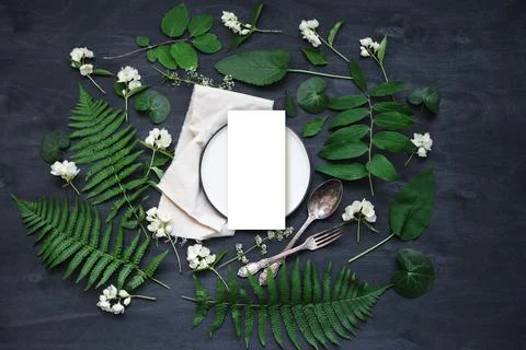 Beautiful boho spring table set up mockup with wild flower and plant decorati Foto stock