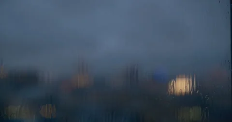 Beautiful bokeh effect with blurred urban evening scene, water droplets Stock Footage 337617697