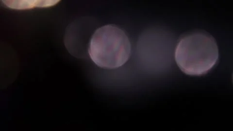 Beautiful bokeh light in different colors in the dark Vídeo Stock 317459390