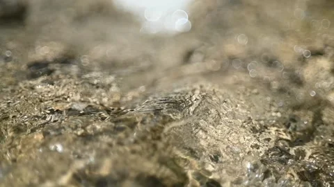 Beautiful bokeh of a small waterfall from a mountain stream (slow motion) Video stock 219634731
