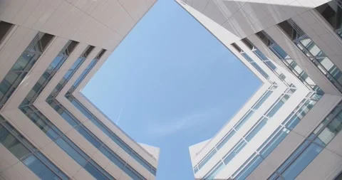Beautiful bottom view of office building against the background of the blue sky Видео 163677417