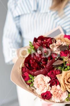 Beautiful bouquet of mixed flowers in woman hand. Floral shop concept Stock Photos