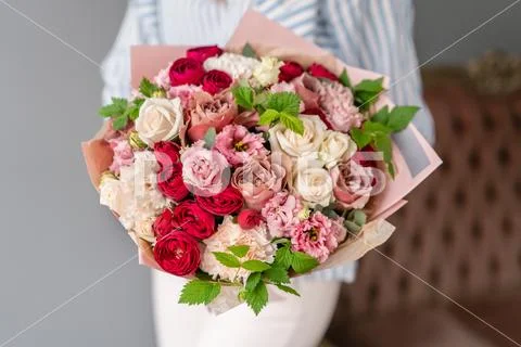 Beautiful bouquet of mixed flowers in woman hand. Floral shop concept Stock Photos