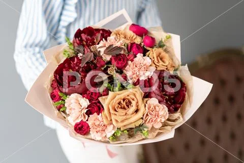 Beautiful bouquet of mixed flowers in woman hand. Floral shop concept Stock Photos