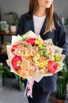 Beautiful bouquet of mixed flowers in woman hand. Floral shop concept Stock Photos