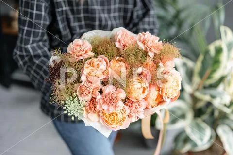 Beautiful bouquet of mixed flowers in woman hand. Floral shop concept . Handsome Stock Photos