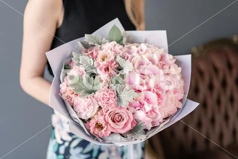 Beautiful bouquet of mixed flowers in woman hand. Floral shop concept . Handsome Stock Photos