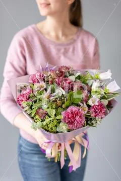 Beautiful bouquet of mixed flowers in woman hand. Floral shop concept . Handsome Stock Photos