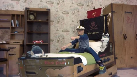 Beautiful boy on the bed playing in the sailor. Stock-Footage 79617512