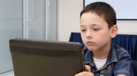 Beautiful boy playing the tablet, slow motion 2 Stock-Footage 52055133