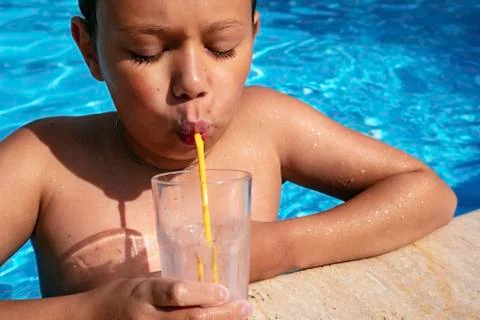 Beautiful boy with relaxing at swimming pool 스톡 사진