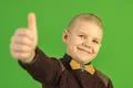 The beautiful boy show thumb up on the green background Photo