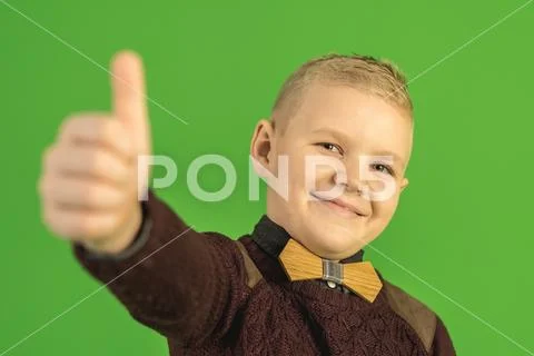 The beautiful boy show thumb up on the green background Stock Photos