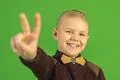 The beautiful boy show thumb up on the green background Photo