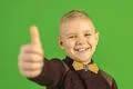 The beautiful boy show thumb up on the green background Photo