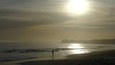 Beautiful Boy Standing By Ocean With Sun Stock Footage