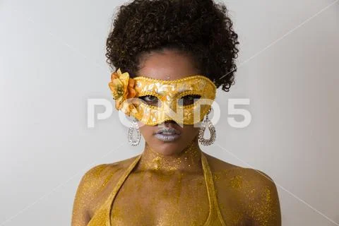 Beautiful Brazilian afro girl ready for the carnival. Golden body painting. F Stock Photos