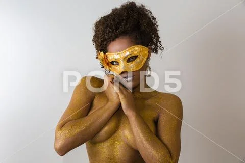 Beautiful Brazilian afro girl ready for the carnival. Golden body painting. F Stock Photos