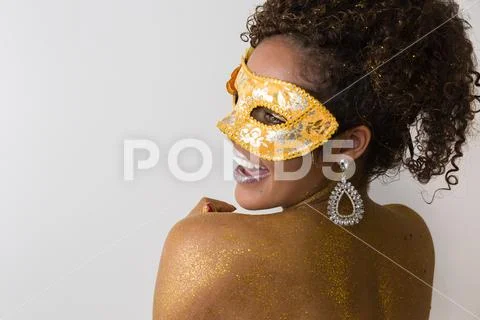 Beautiful Brazilian afro girl ready for the carnival. Golden body painting. F Stock Photos